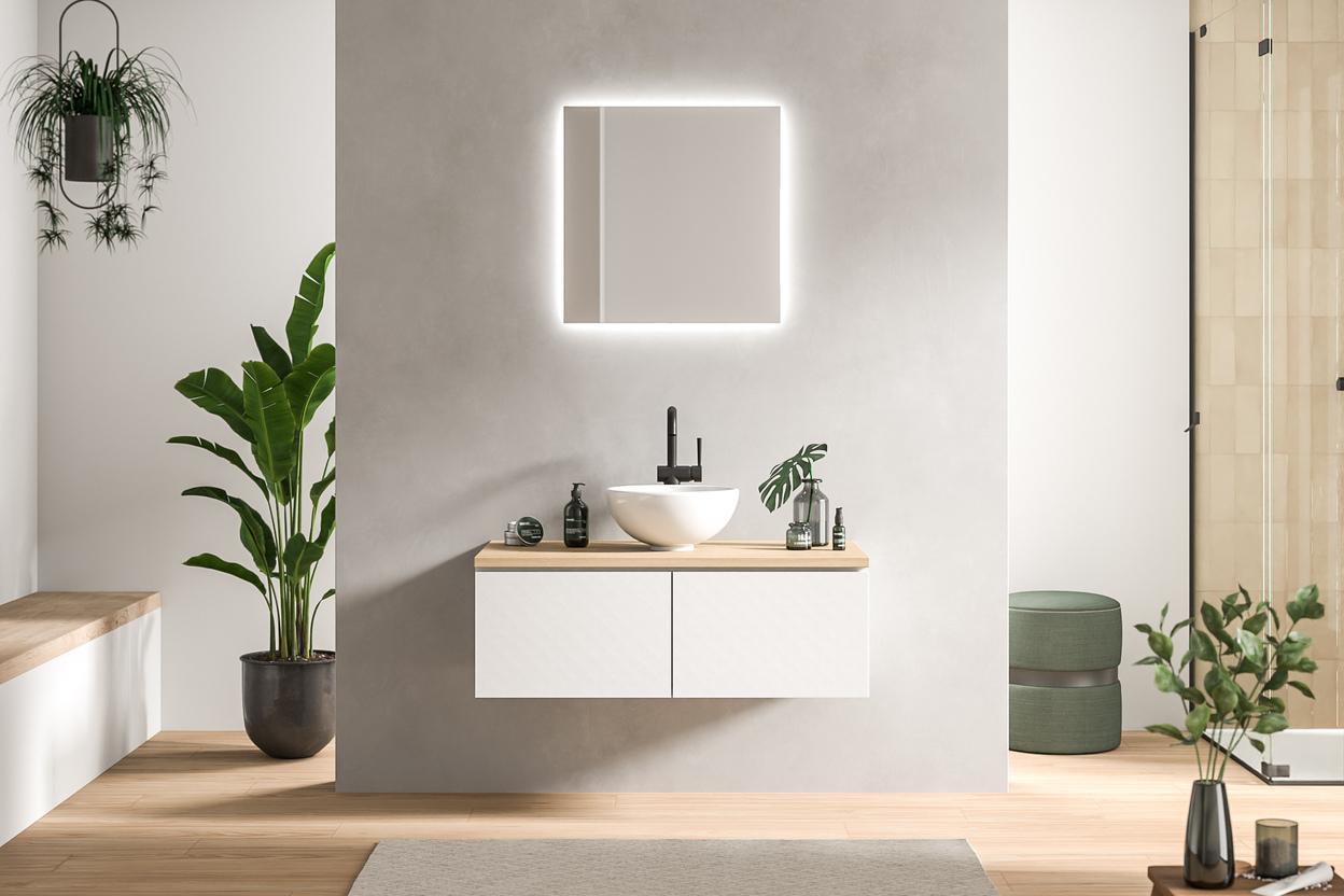 Modernes Bad nach Mass mit heller Ästhetik Minimalistisch designtes Bad nach Mass mit schwebendem Waschtisch in Weiss, beleuchtetem Spiegel und grünen Pflanzendetails.